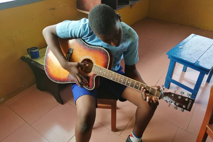 Learner playing guitar